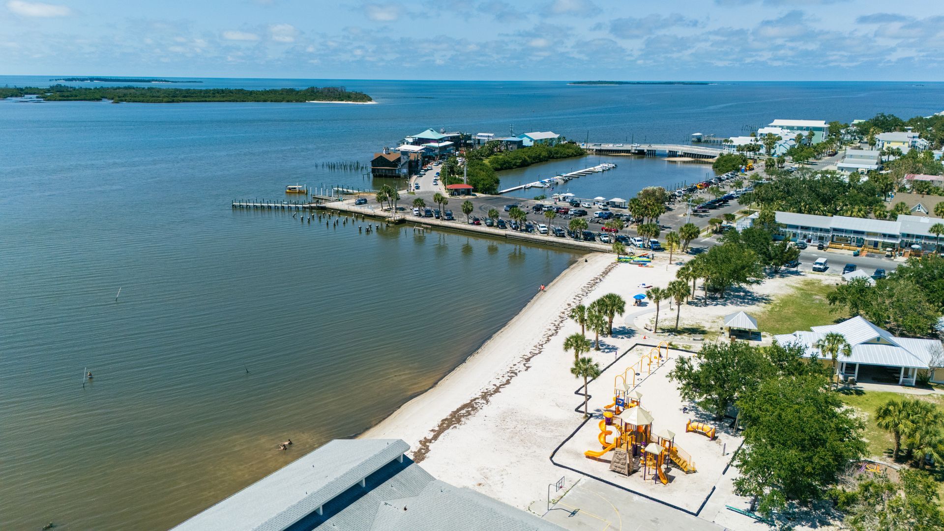 An aerial view of a small town next to a body of water.
