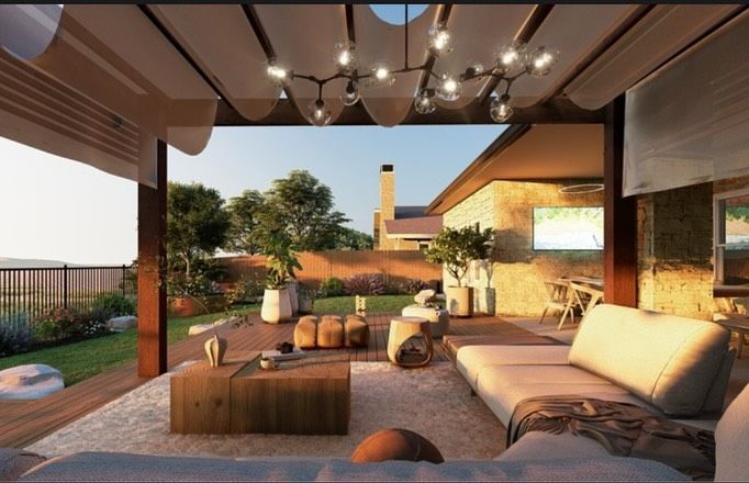 Outdoor patio with a modern seating area, view of a yard and a distant house.