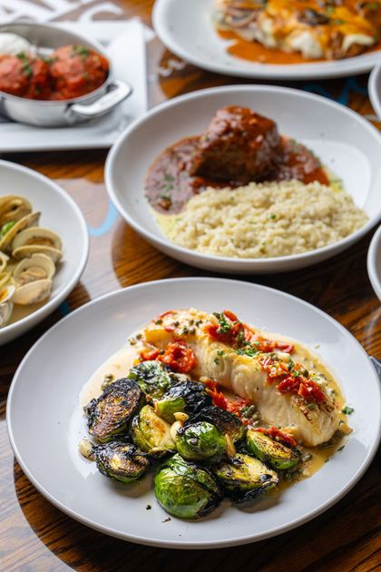 A table topped with plates of food and bowls of food.