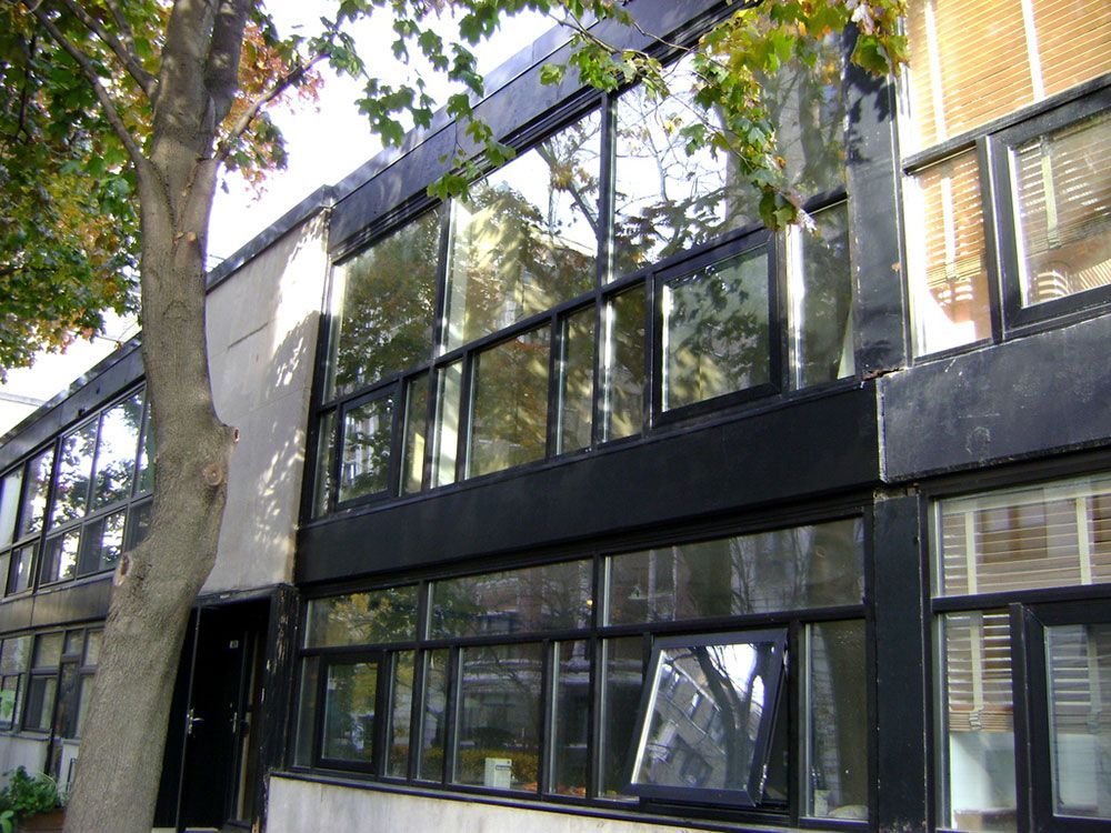 A building with a lot of windows and a tree in front of it