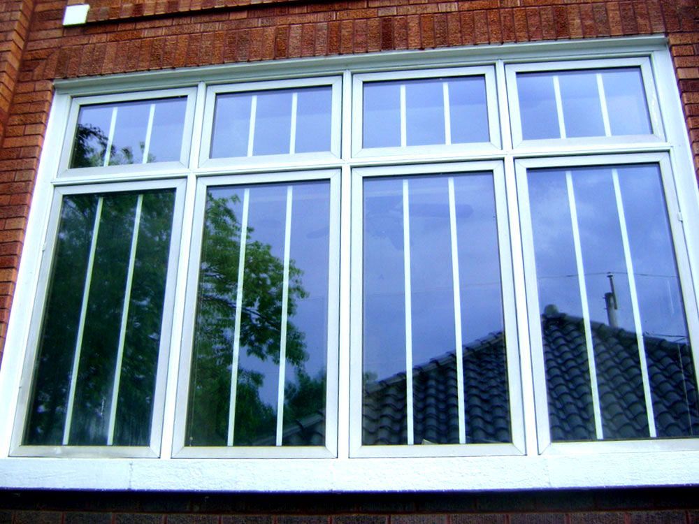 A window on a brick building with a white frame