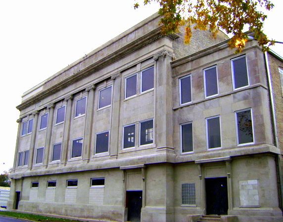 A large building with a lot of windows and a tree in front of it