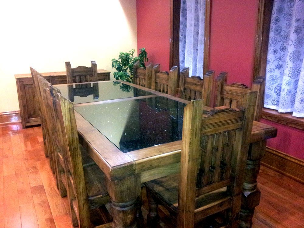 A wooden table and chairs in a room with red walls