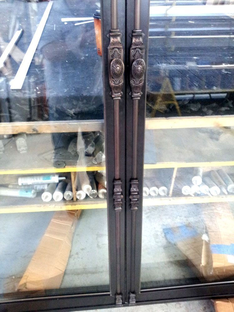 A close up of a glass door with metal handles