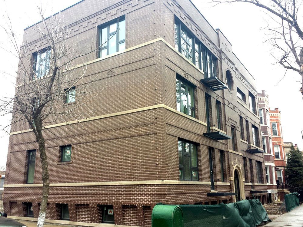 A large brown brick building with a lot of windows