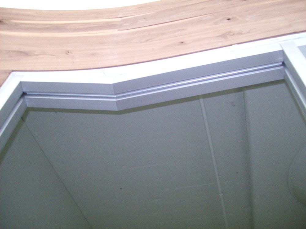 A white door with a wooden ceiling in the background