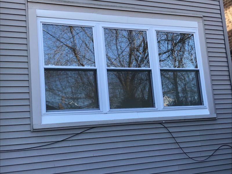A large window is on the side of a house.