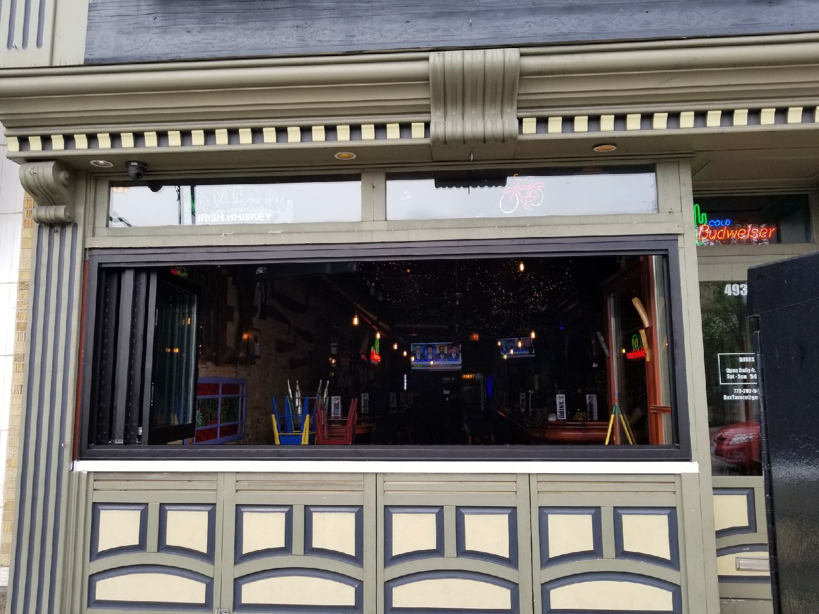 A restaurant with a large window and a neon sign