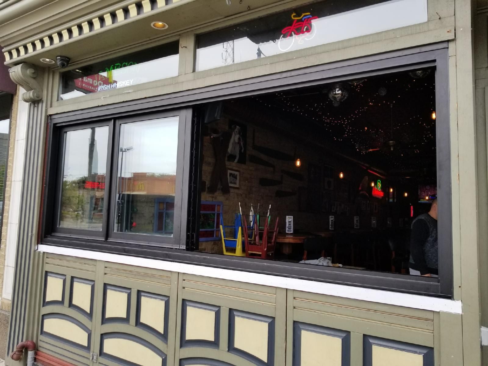 A restaurant with a sliding glass door and a large window.