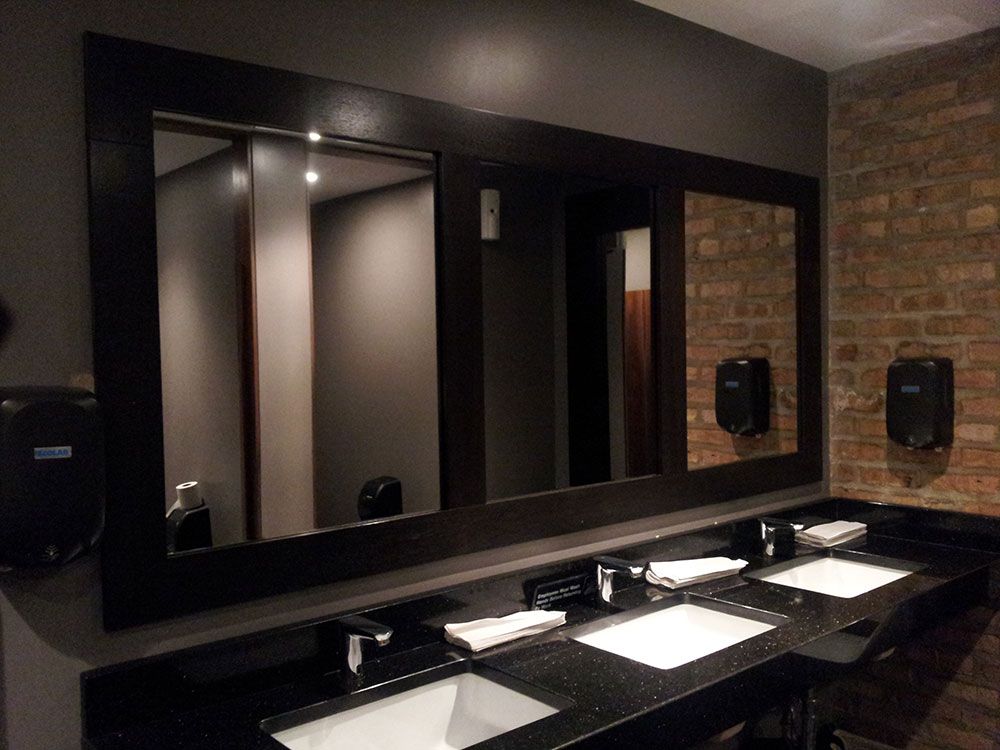 A bathroom with two sinks and three mirrors