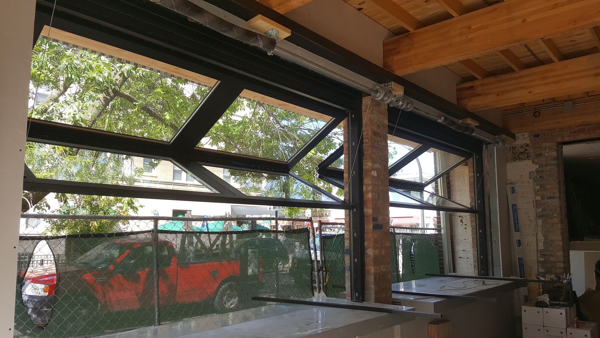 A room with a lot of windows that are open