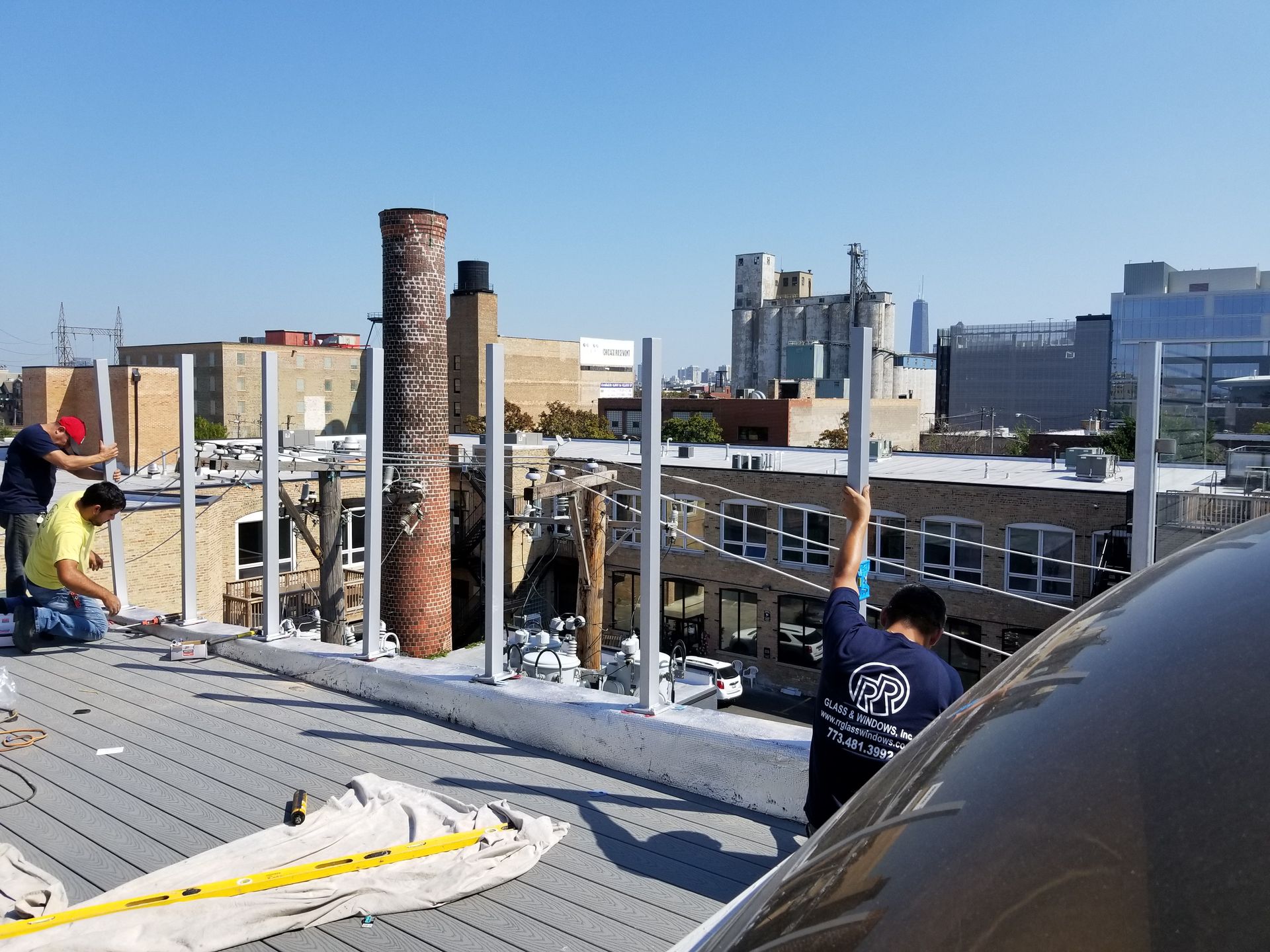 Two men are working on the roof of a building.