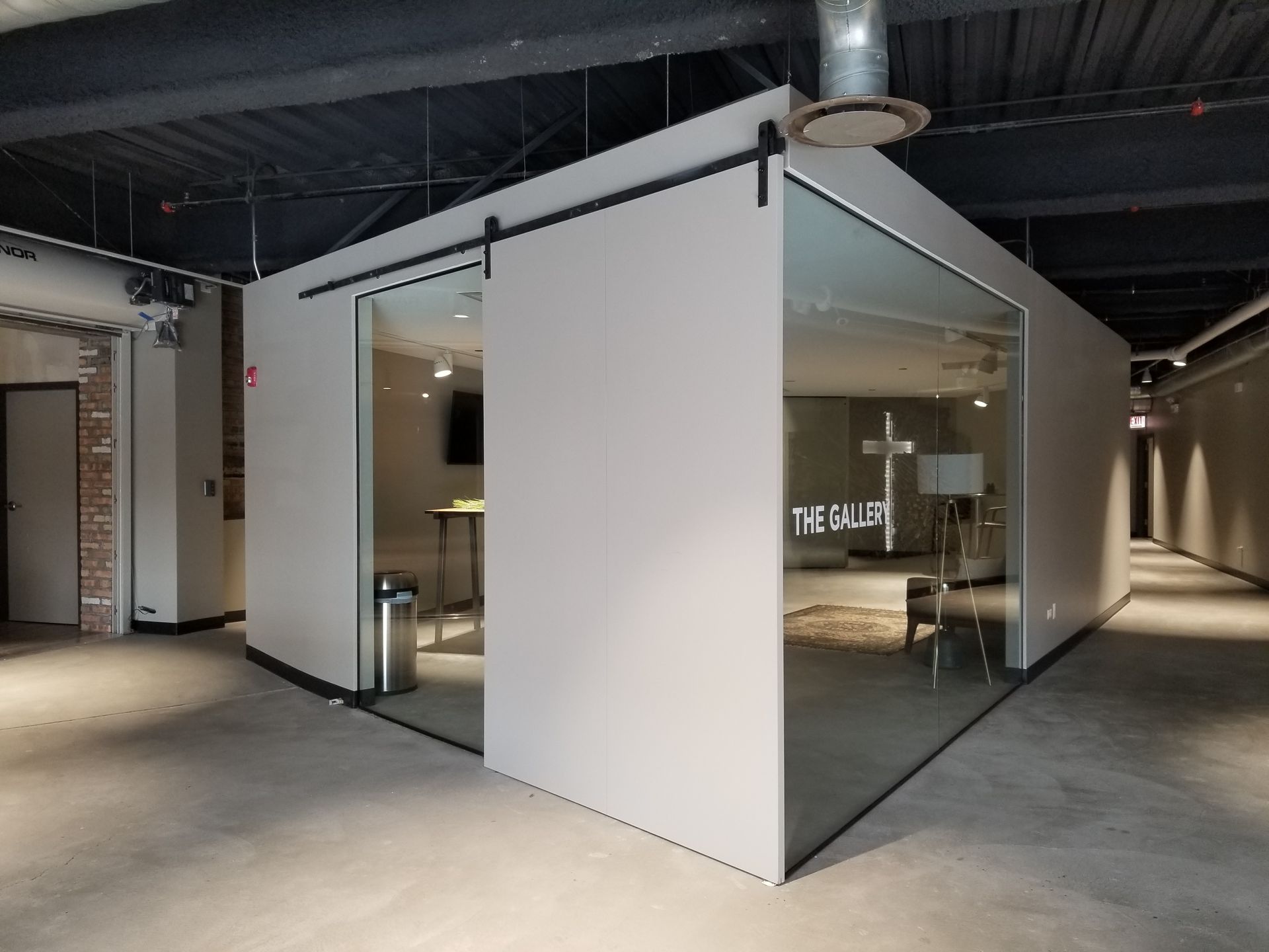 A room with a sliding glass door that says the gallery