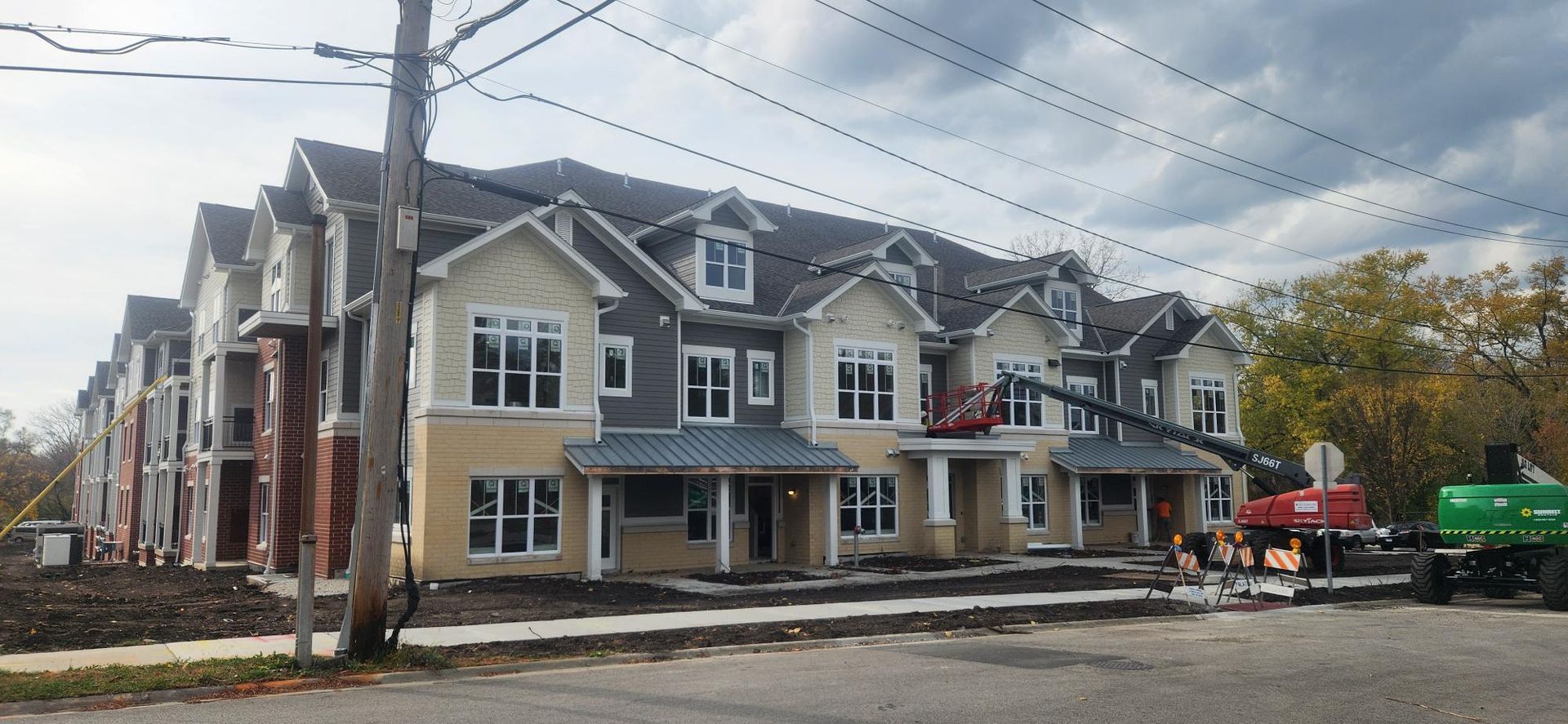 A row of apartment buildings under construction on a cloudy day
