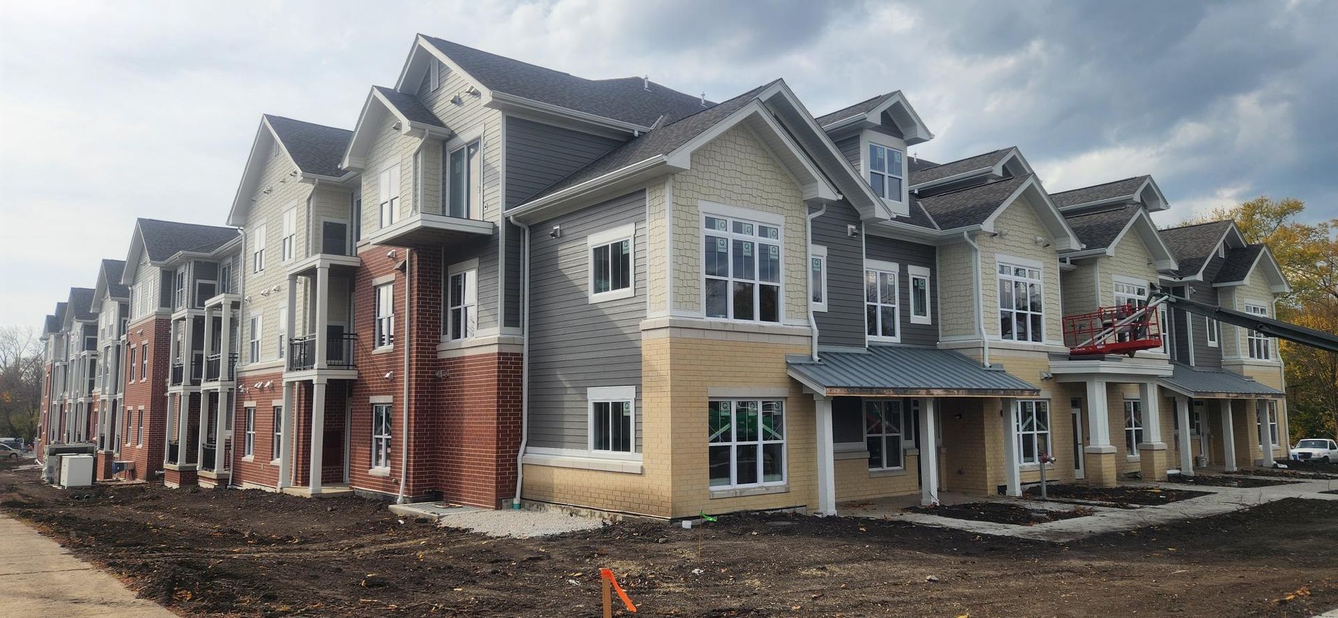 A large apartment building under construction with a lot of windows.