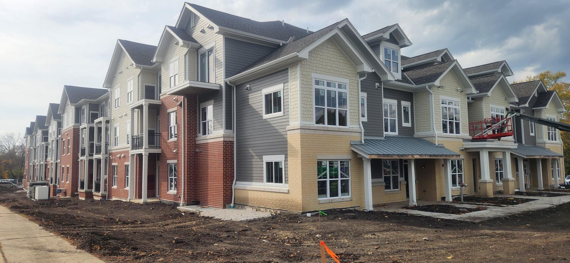 A row of houses are being built in a residential area.