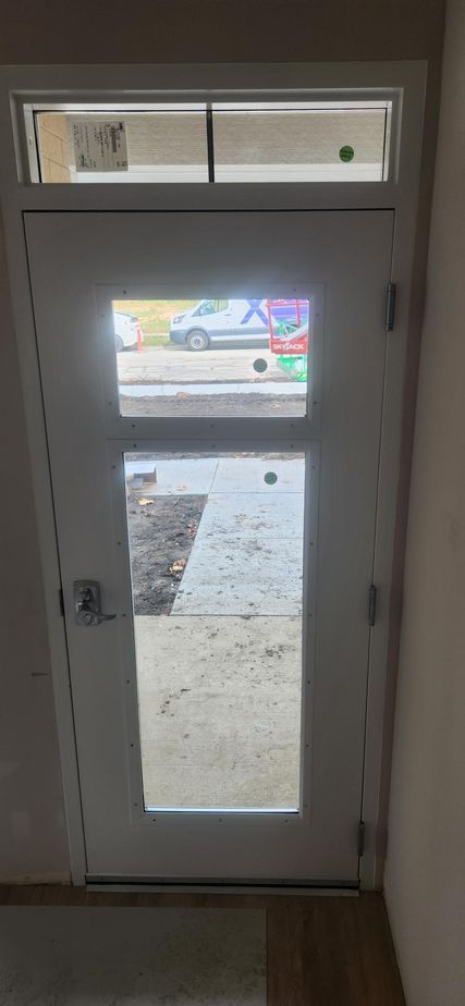 A white door with a window and a ceiling above it.