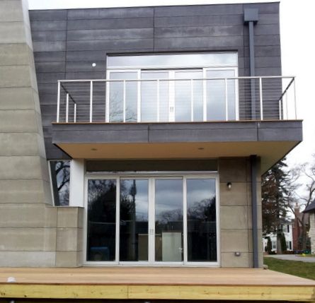 A house with a balcony and lots of windows