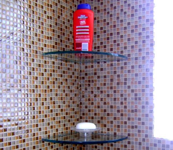 A red bottle of shampoo sits on a glass shelf