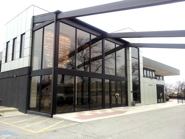 A large building with a lot of windows and a handicapped parking spot