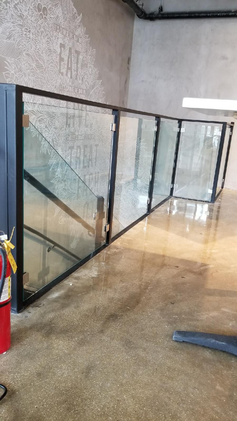 A staircase with a glass railing in a building.