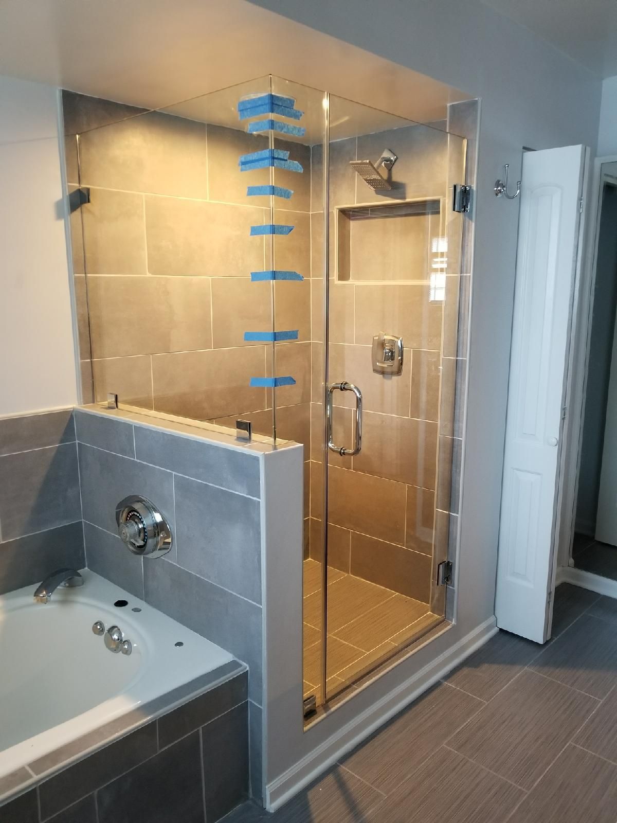 A bathroom with a walk in shower and a bathtub.