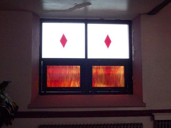 A stained glass window with a red diamond in the middle