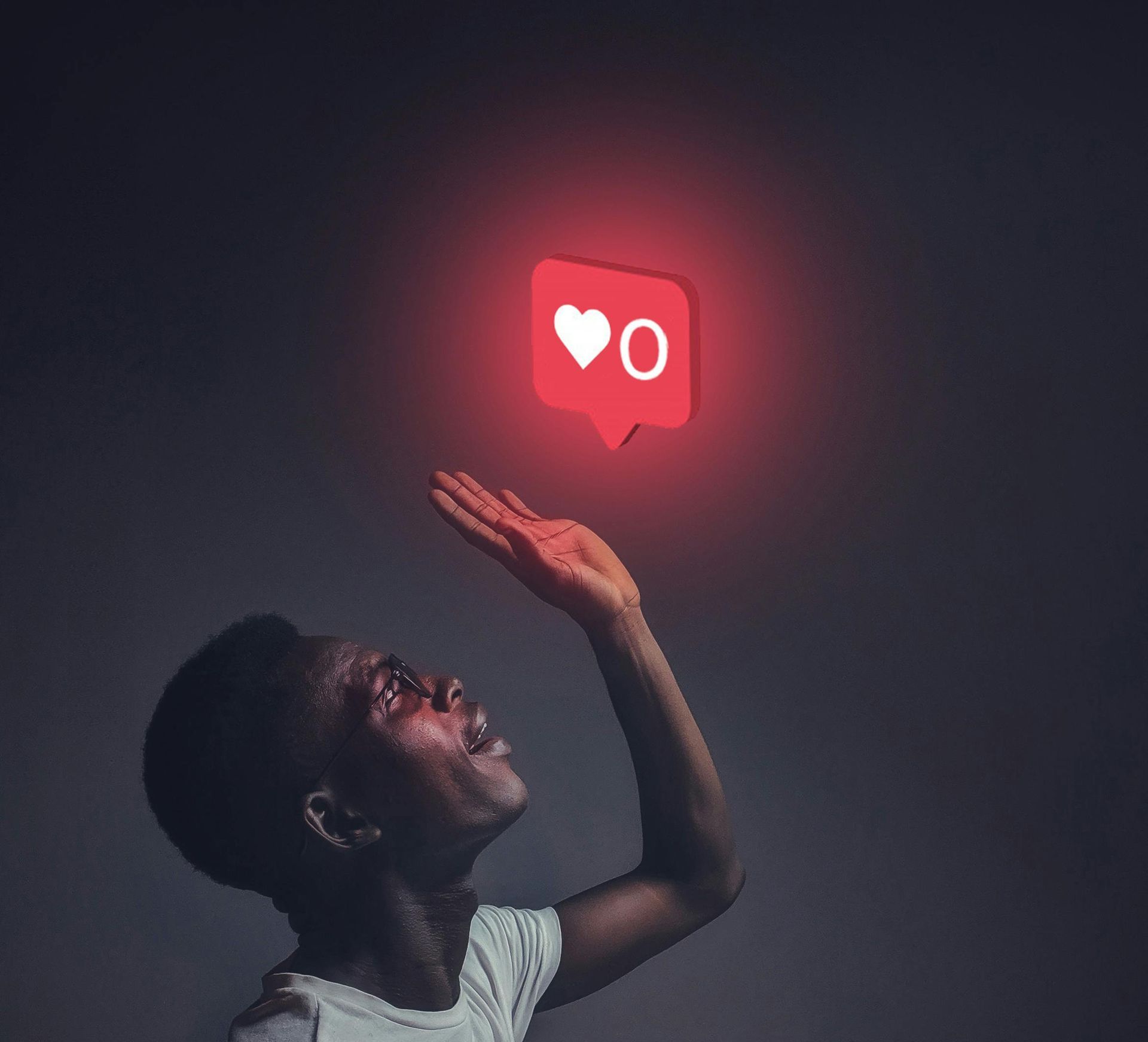 A man is reaching up towards a red like icon