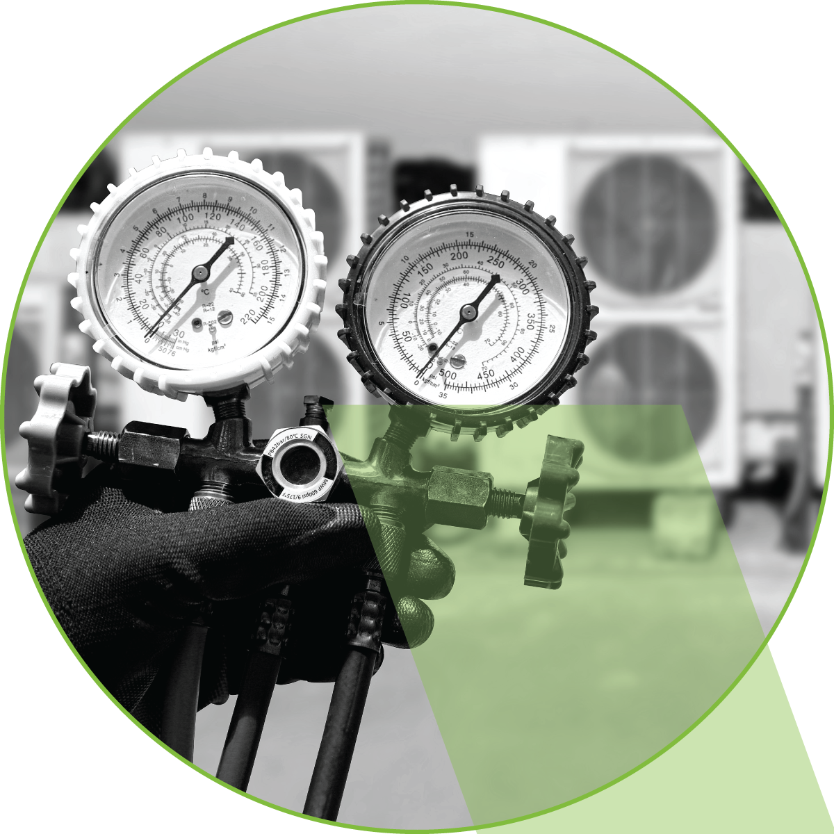 Two pressure gauges on industrial equipment, one white and one black, against a blurred factory background