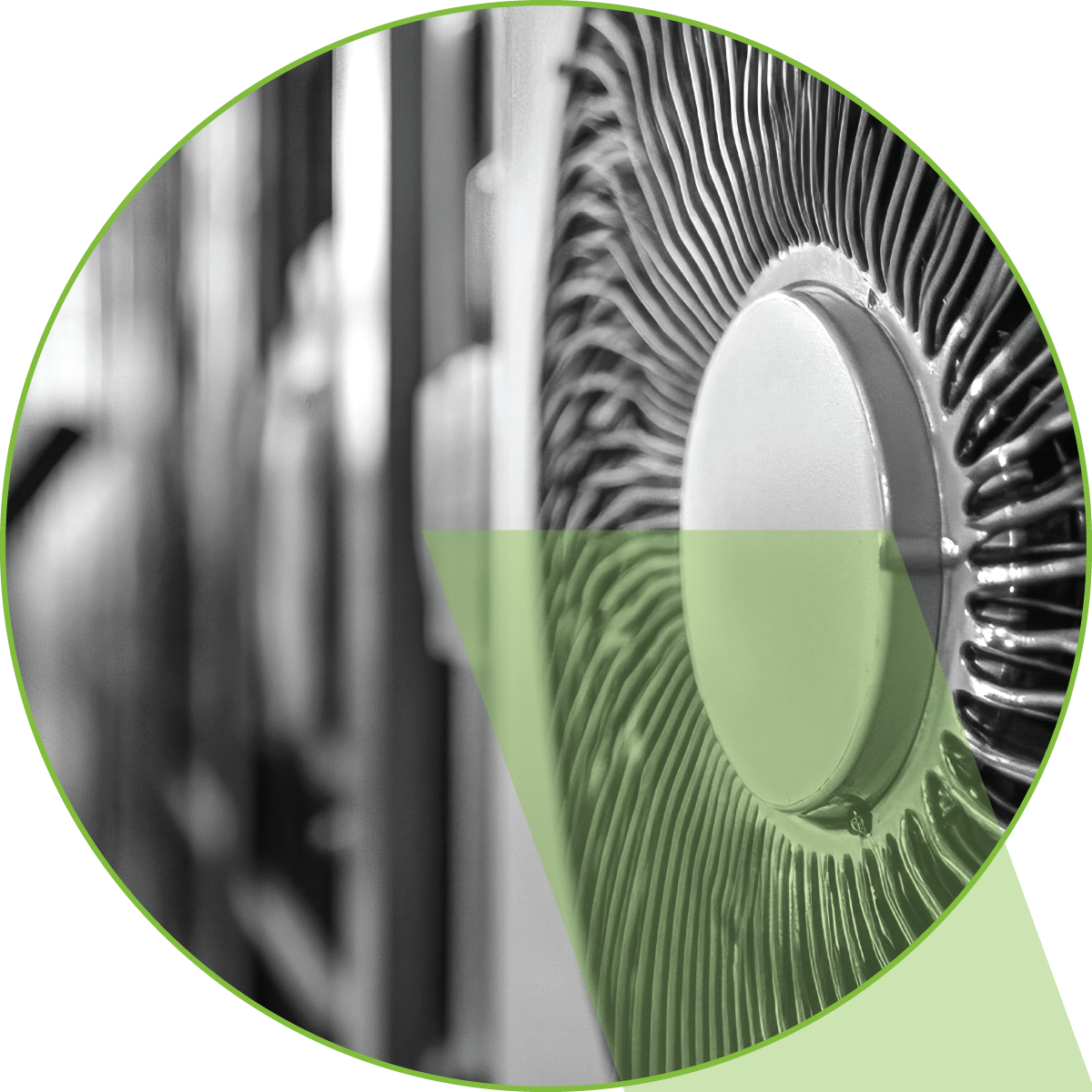 Circular close-up of a silver fan or speaker grille with a green-tinted overlay