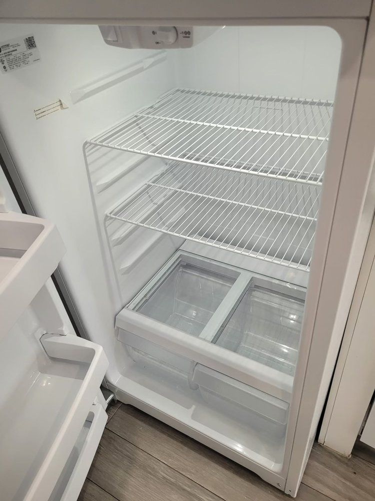 The inside of an empty refrigerator with the door open.