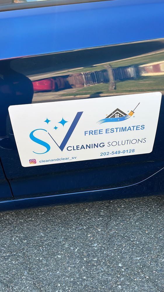 A blue car with a sign on the side that says `` free estimates cleaning solutions ''.