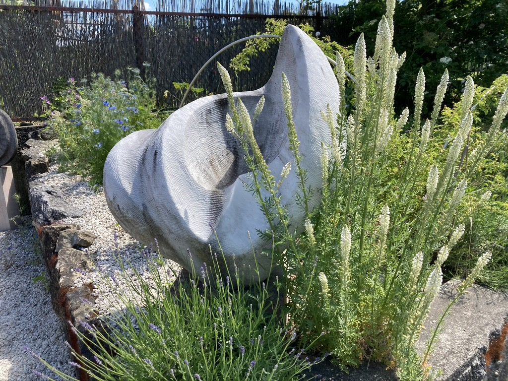 „Steinskulptur im Garten – Symbol für Ruhe und spirituelle Trauerbegleitung