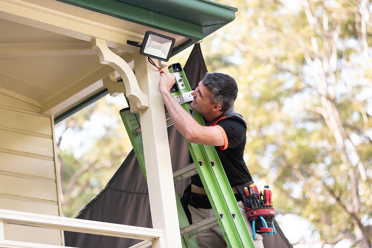 An Electrician In Sippy Downs Repairing An Outdoor Light Fitting