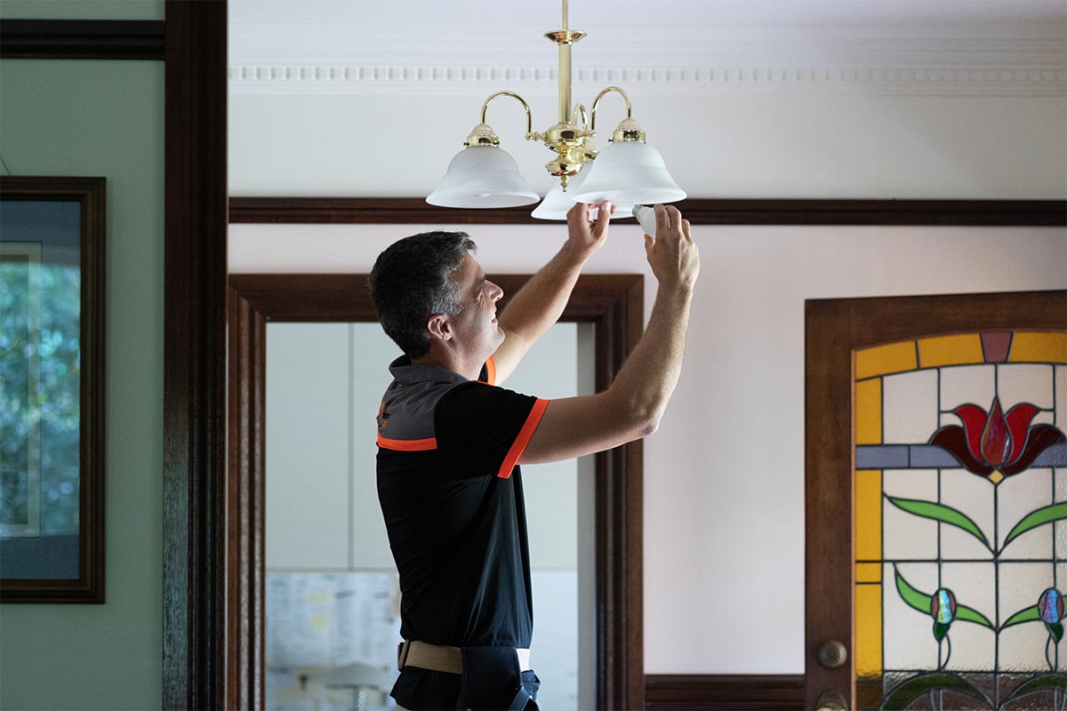 Local Electrician In Mountain Creek Repairing A Light Fixture