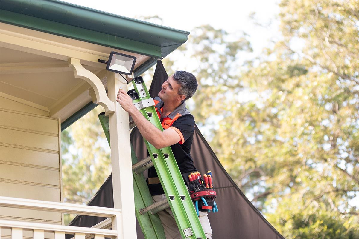 Maroochydore Electrician Up Extension Ladder Repairing External Lights