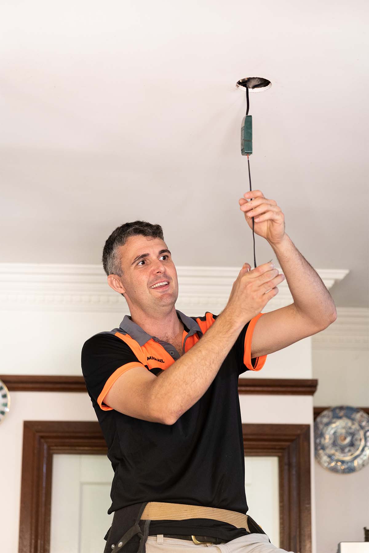 Sunshine Coast Electrician Installing A LED Downlight