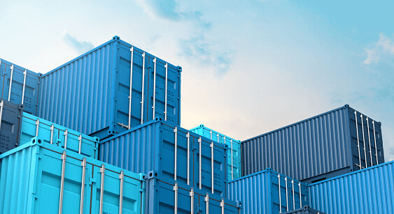 Blue shipping containers stacked against a cloudy sky.