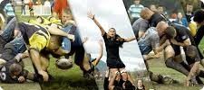 Rugby players in action, one woman celebrating, others tackling and running on a grass field.