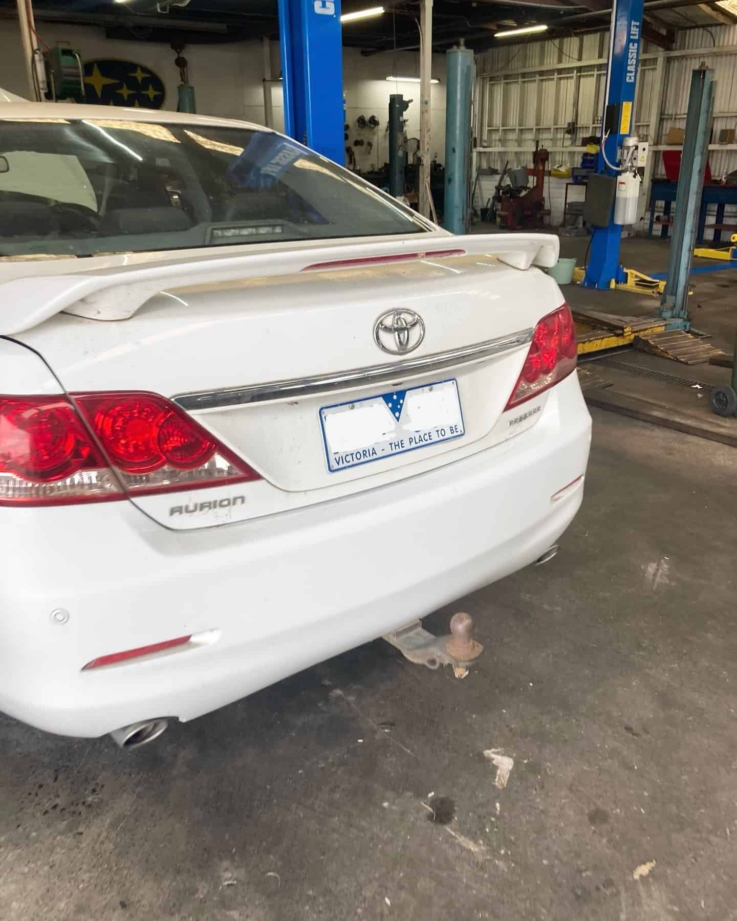 A White Toyota Car Is Parked In A Garage — NEID Automotive In North Gosford, NSW
