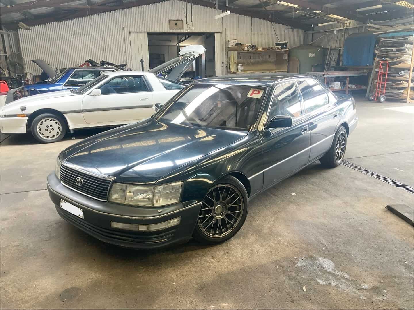 Green Car in Mechanic Shop