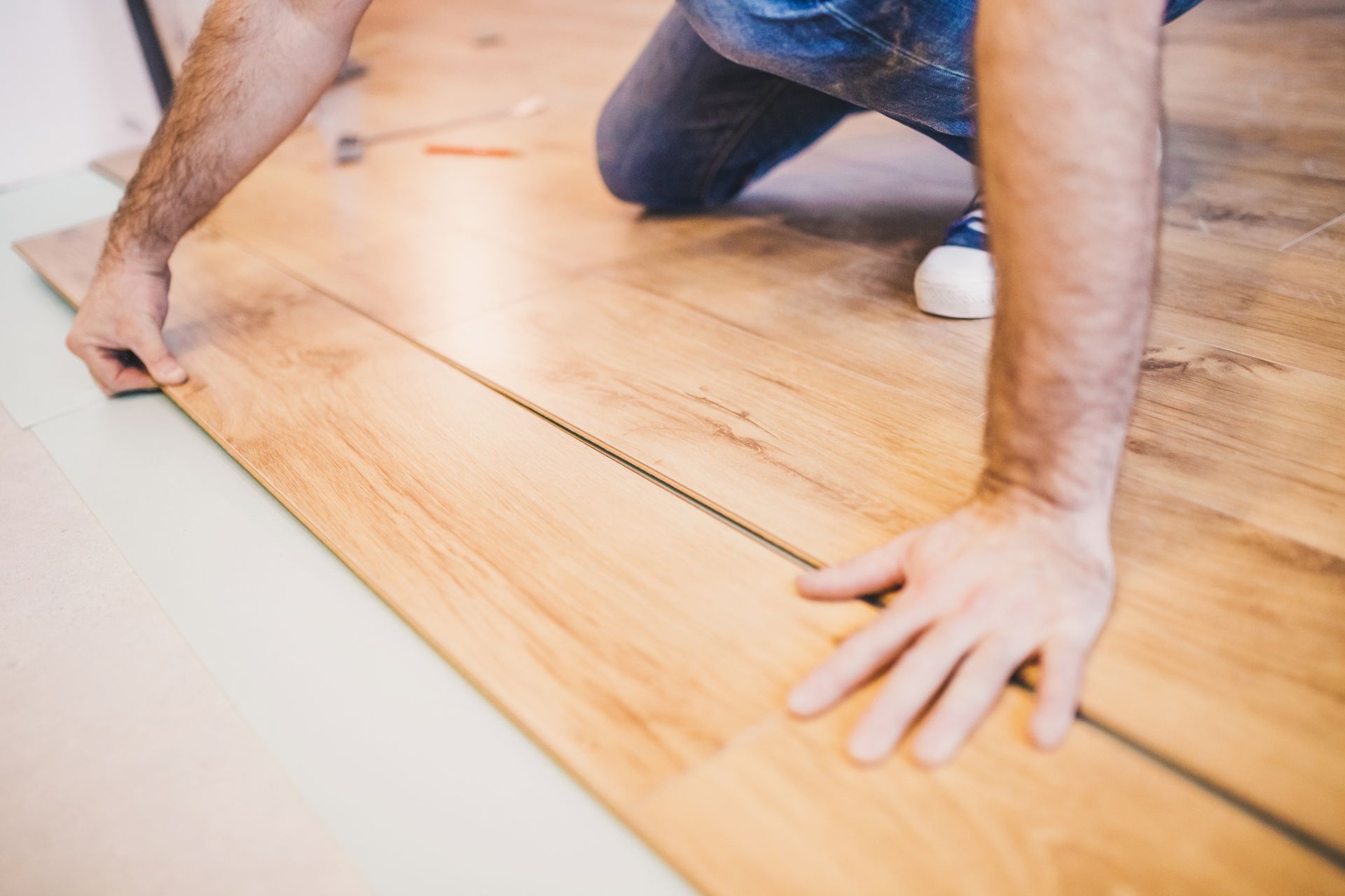 Close-up of a worker installing waterproof planks on a house in Colorado Springs, CO.