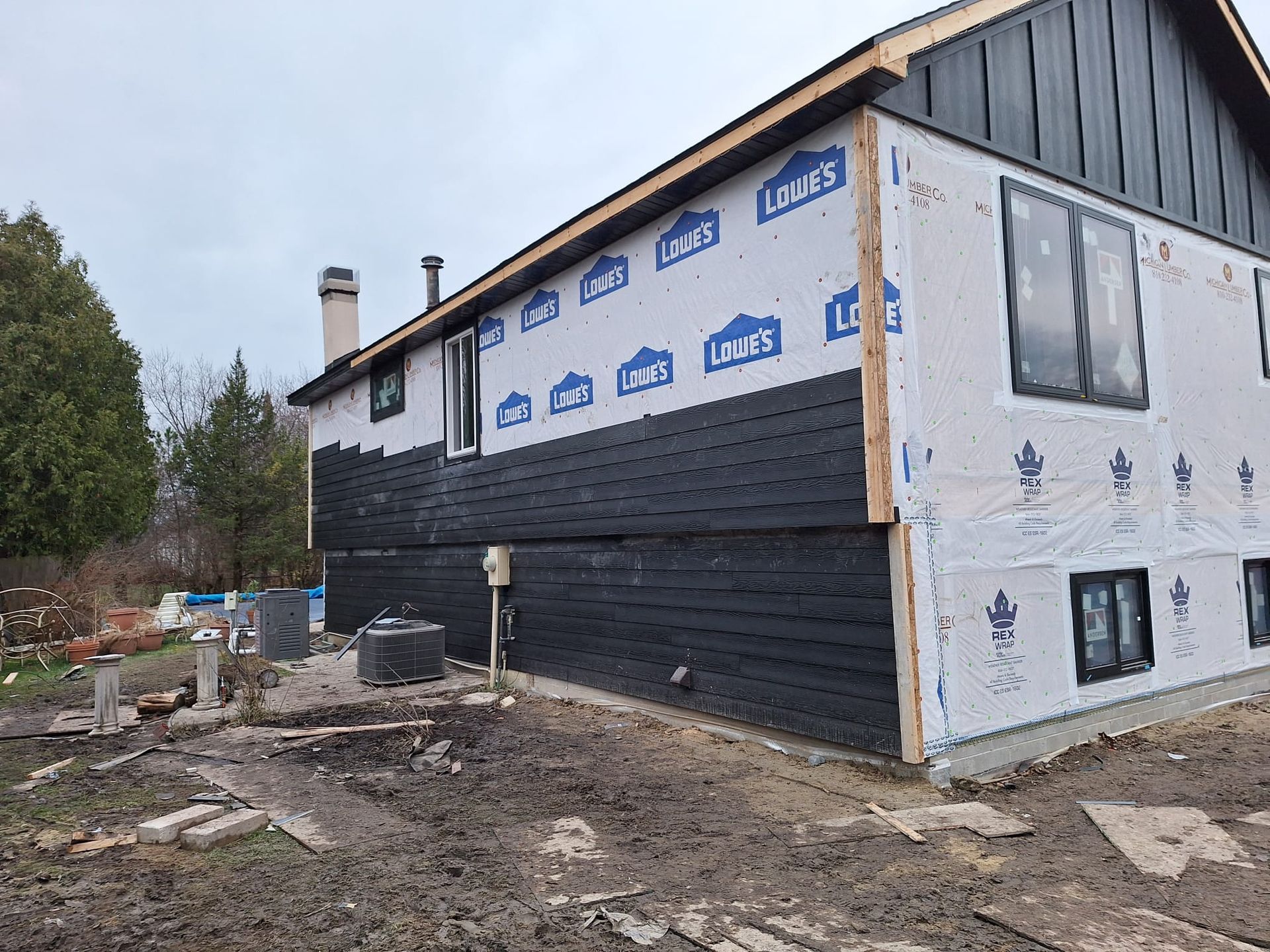 A large house with a lot of windows is being built.