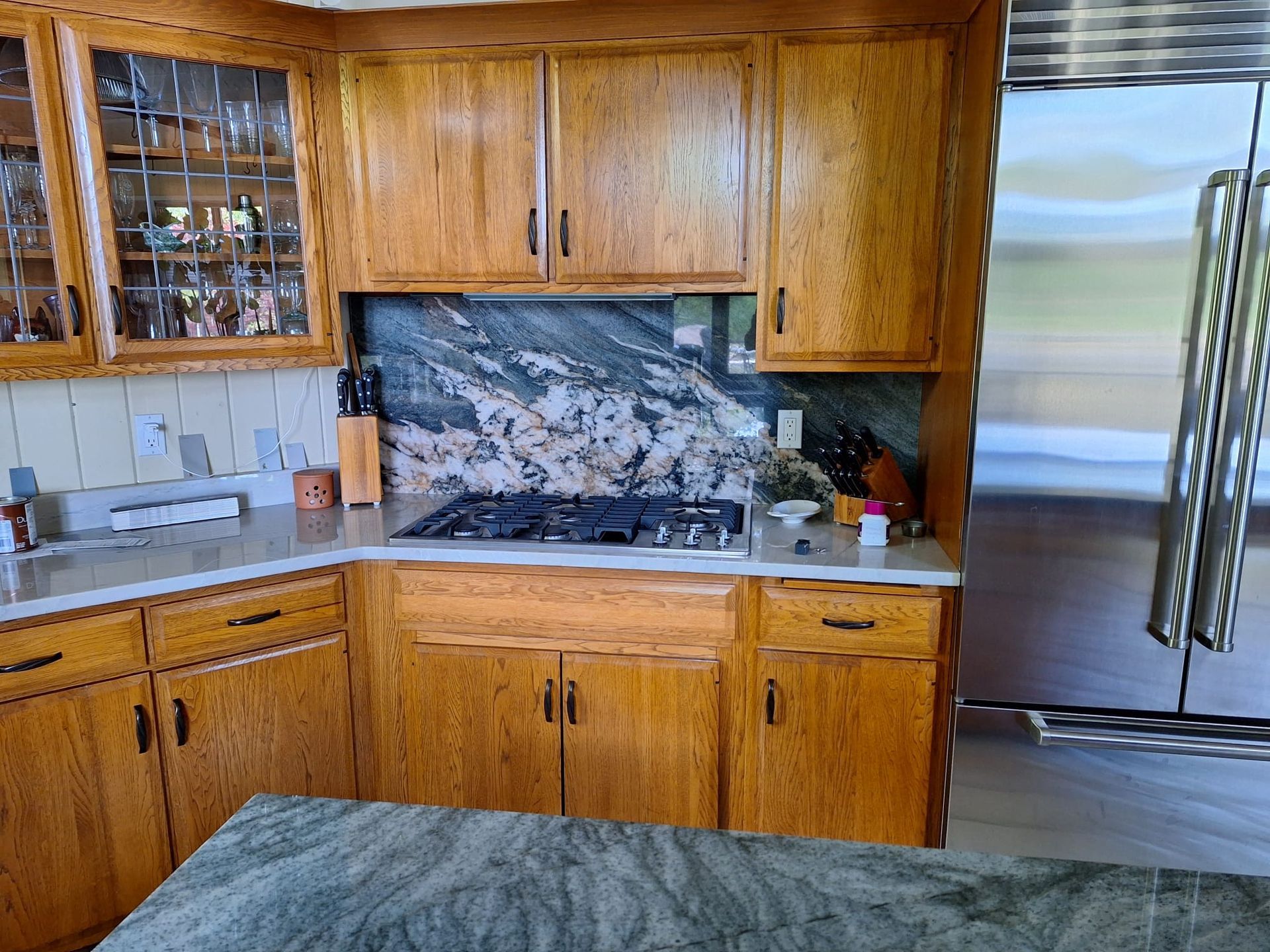 A kitchen with wooden cabinets and stainless steel appliances
