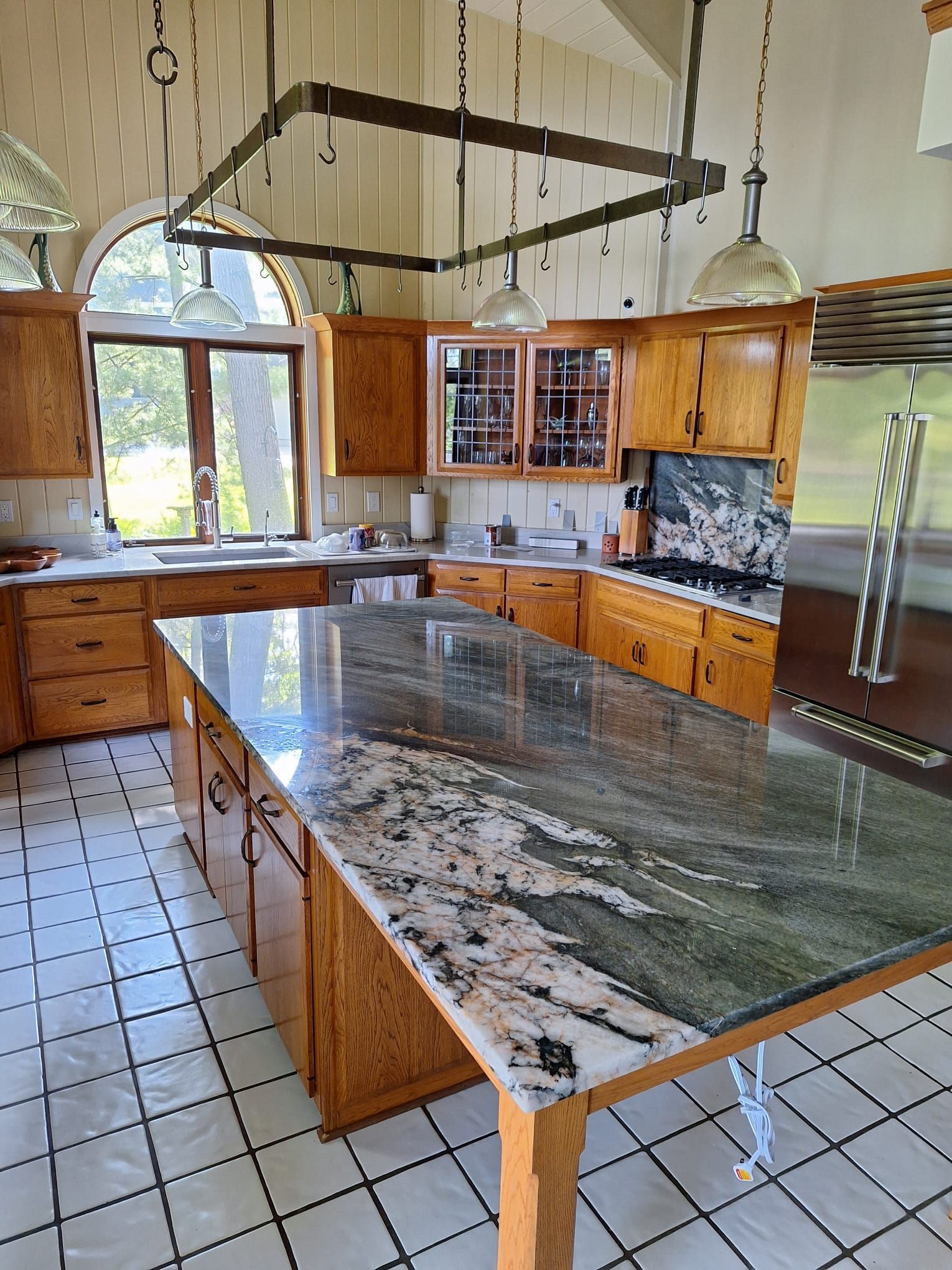A kitchen with granite counter tops and wooden cabinets