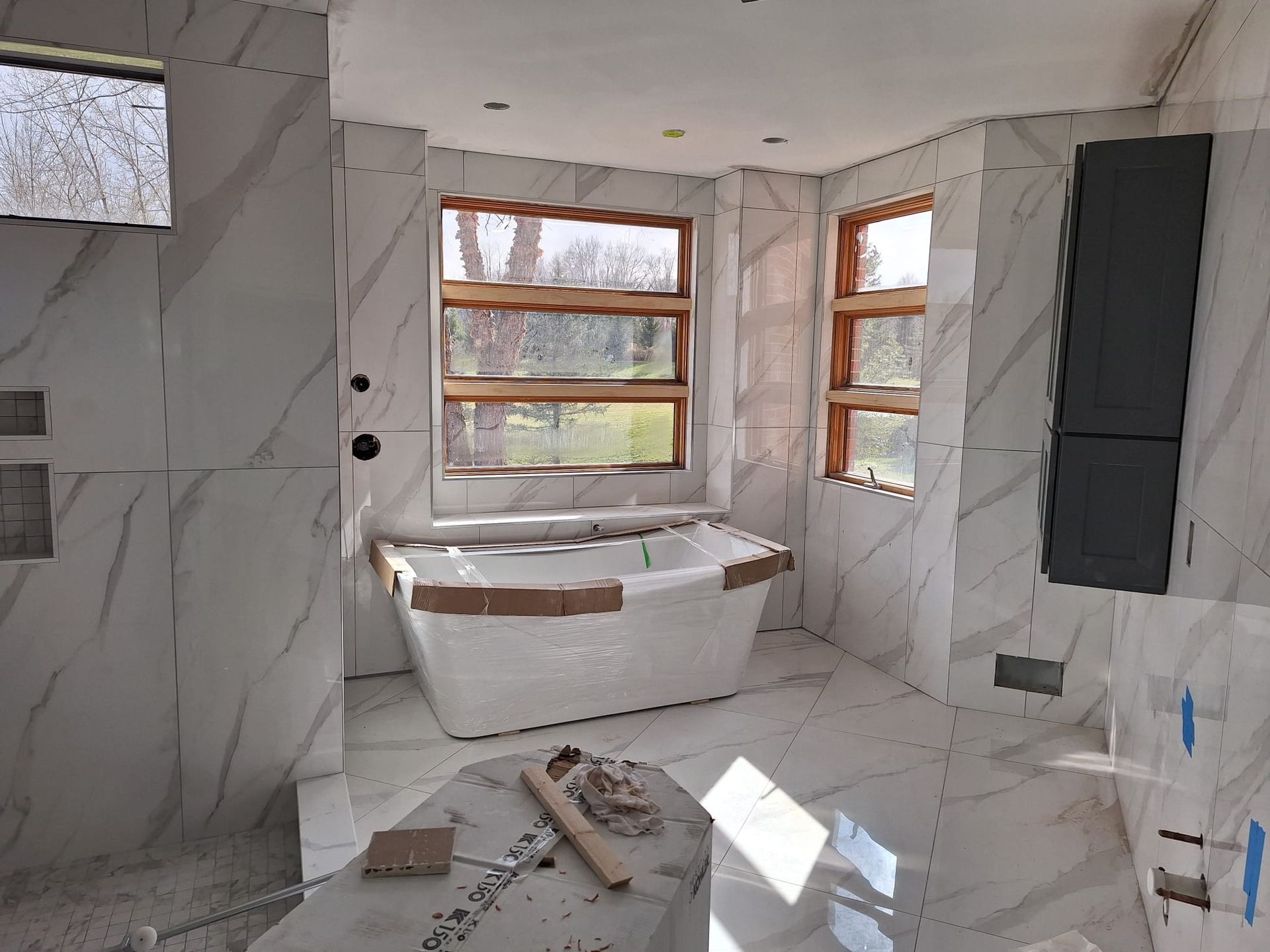 A bathroom with marble tiles and a bathtub in it
