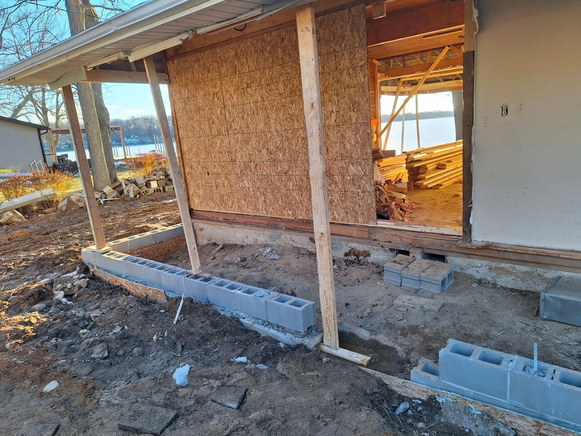 A house is being built on top of a dirt field.
