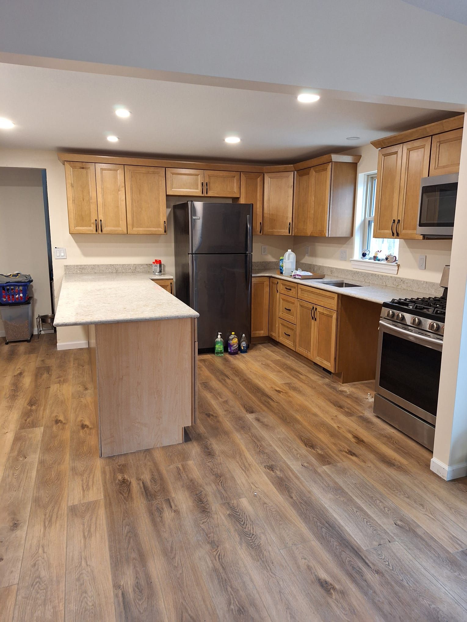 A kitchen with wooden cabinets and stainless steel appliances