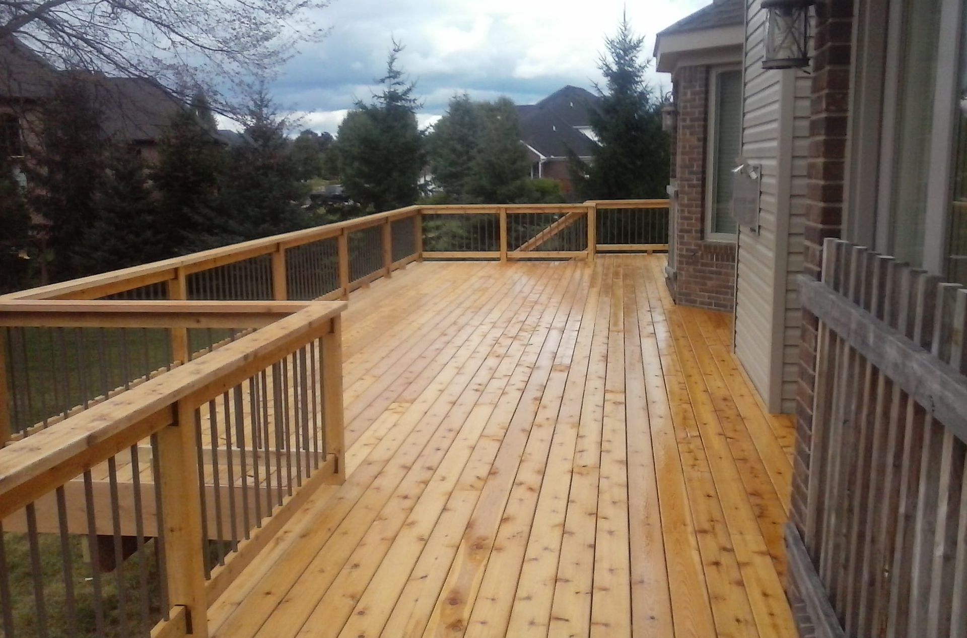 A large wooden deck with a fence around it