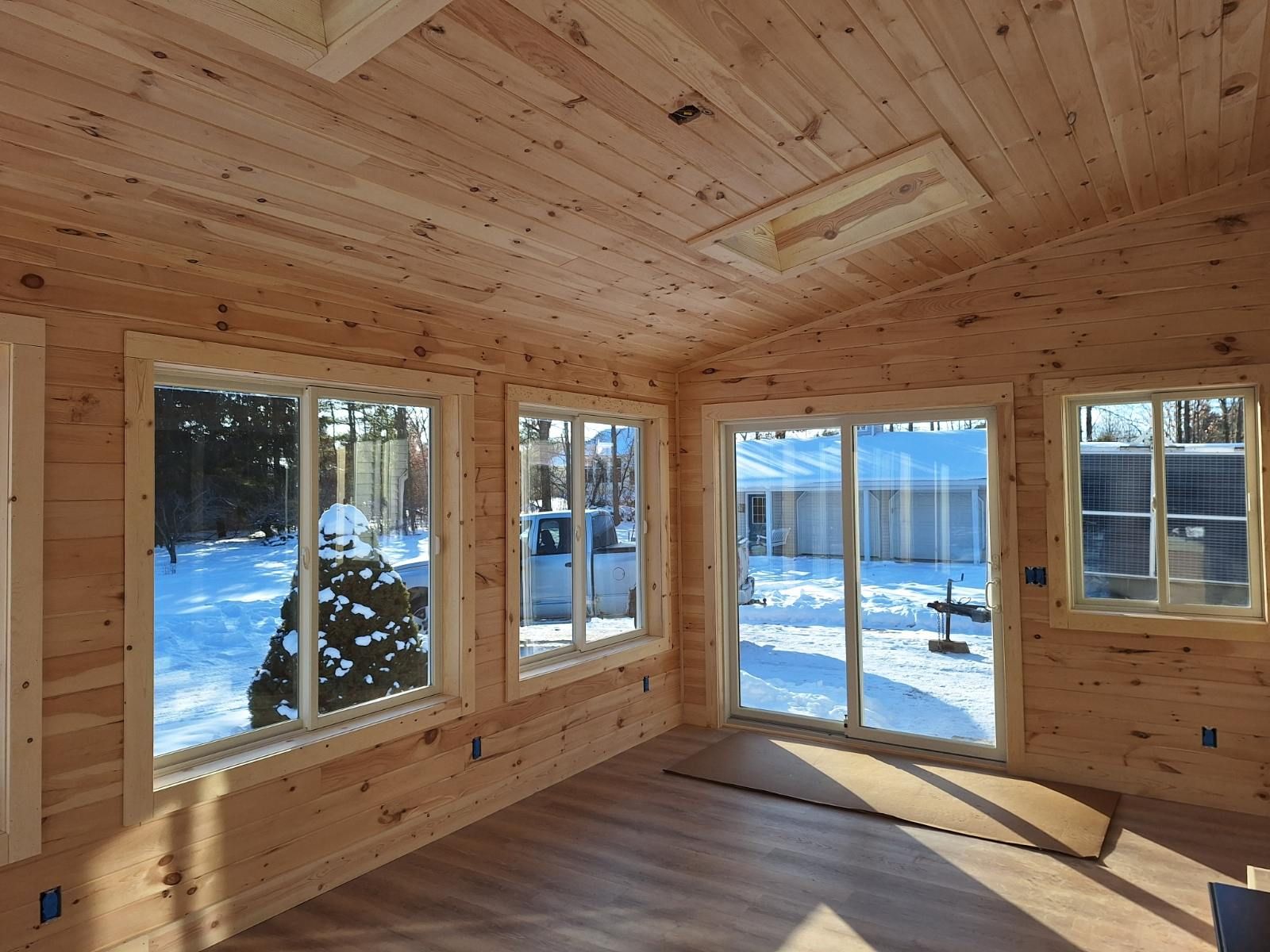 interior of four-season room addition with sliding patio door and knotty pine walls, Lapeer County, MI